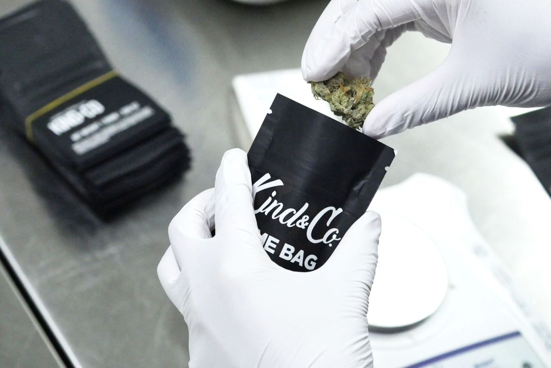 Flower going into a Kind & Co Dime Bag